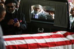 Mourners look on as the casket of Walter Scott is removed from a hearse for his funeral at W.O.R.D. Ministries Christian Center, April 11, 2015 in Summerville, South Carolina. Scott was killed by a North Charleston police officer after a traffic Saturday, April 4, 2015. The officer, Michael Thomas Slager, has been charged with murder. 