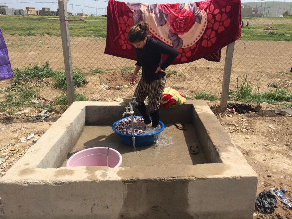 Amid all the uncertainty, a woman carries out domestic tasks. Yazidis are of Kurdish descent, and their religion is considered a pre-Islamic sect that draws from Christianity, Judaism and Zoroastrianism.