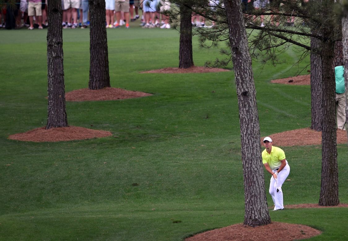 Rory McIlroy hits out of the trees on the seventh hole at Augusta. He birdied the hole and picked up more shots at eight and 11 to continue his bid for a top-five finish. 