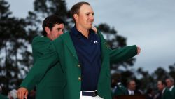 Defending champion Bubba Watson presents Jordan Spieth with the champion green jacket after he won the 2015 Masters Tournament on April 12 in Augusta, Georgia.