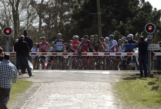 Some cyclists during the Paris-Roubaix race took their life into their own hands during a level -- or railway -- crossing, not stopping as the barrier went down. These cyclists, however, did stop.  