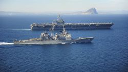 STRAIT OF GIBRALTAR - MARCH 31: In this handout provided by the U.S. Navy, the Ticonderoga-class guided missile cruiser USS Vicksburg (CG 69) escorts the Nimitz-class aircraft carrier USS Theodore Roosevelt (CVN 71) by the Rock of Gibraltar March 31, 2015 while transiting the Strait of Gibraltar. Theodore Roosevelt deployed from Norfolk and will execute a homeport shift to San Diego at the conclusion of deployment. Theodore Roosevelt is conducting naval operations in the U.S. 6th Fleet area of responsibility in support of U.S. national security interests in Europe. (Photo by Anthony Hopkins II/U.S. Navy via Getty Images