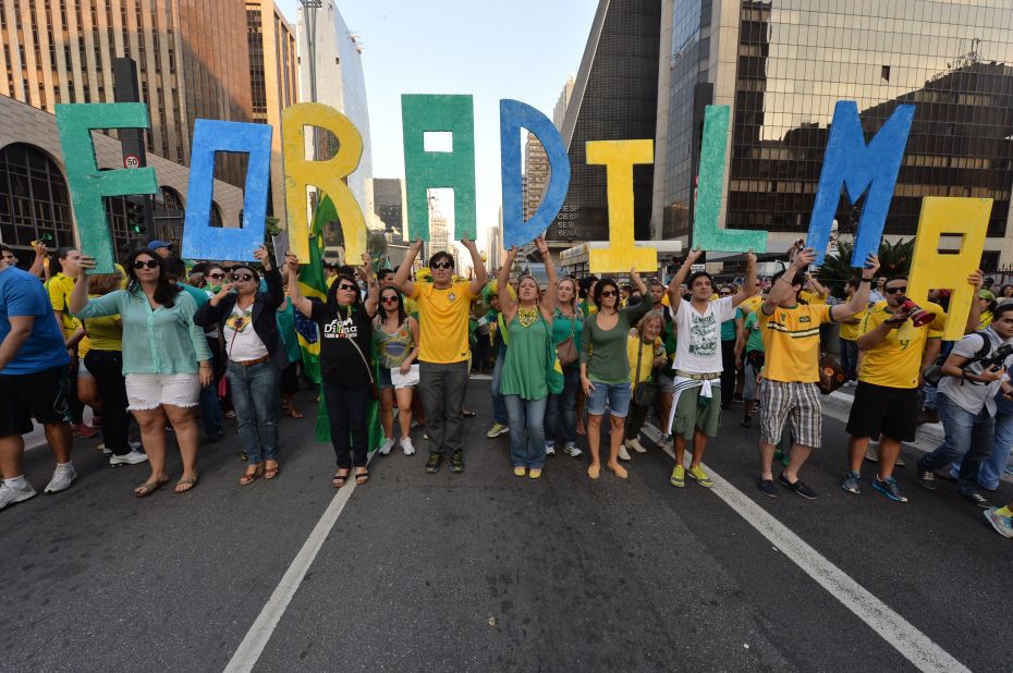 Demonstrators hold letters reading "Dilma out" during a protest against the government of president Dilma Rousseff.