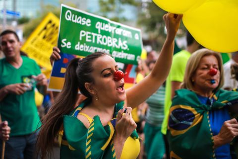 Many demonstrators wore the country's colors -- green, blue and yellow -- waved flags, and chanted: "Out Dilma."