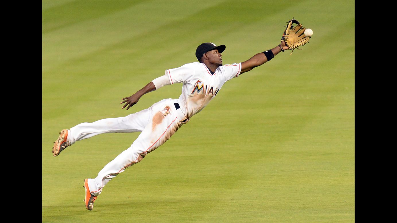 Miami Marlins second baseman Dee Gordon stretches out as he tries to make a catch Friday, April 10, during a home game against Tampa Bay.