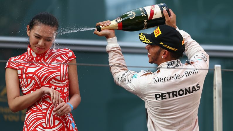 Formula One driver Lewis Hamilton sprays a hostess with champagne after he won the Grand Prix of China on Sunday, April 12. Hamilton, the reigning F1 champion, <a href="index.php?page=&url=http%3A%2F%2Fwww.dailymail.co.uk%2Fnews%2Farticle-3037263%2FStick-cork-Lewis-Formula-One-ace-Lewis-Hamilton-sprays-hostess-girl-face-champagne-winning-Chinese-Grand-Prix.html" target="_blank" target="_blank">received some criticism</a> for spraying the woman, according to the Daily Mail.