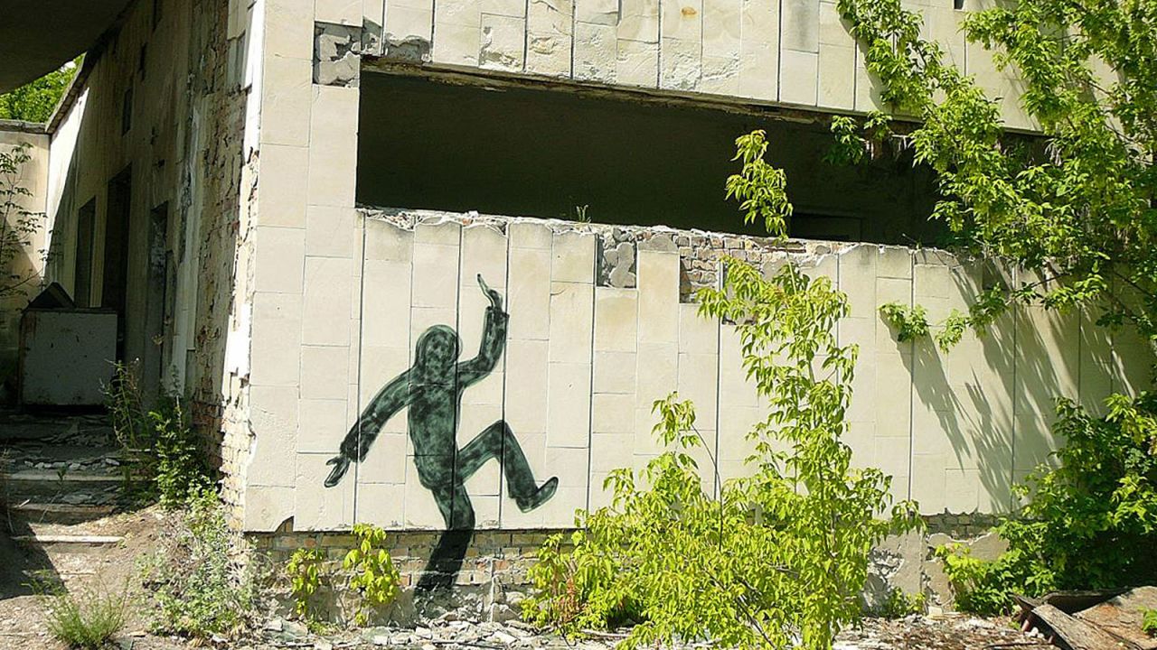 Silhouettes of dancing figures are daubed on walls of Pripyat's buildings, perhaps an attempt to bring a suggestion of human life back. 