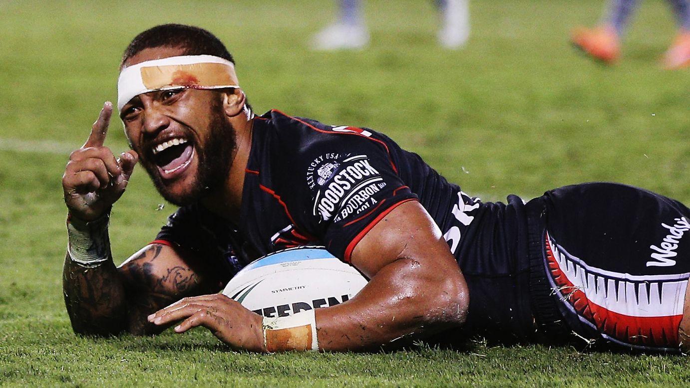 Manu Vatuvei celebrates after scoring a try for the New Zealand Warriors during a National Rugby League match Saturday, April 11, in Auckland, New Zealand. It was Vatuvei's 200th match for the Warriors, who defeated the Wests Tigers 32-22.