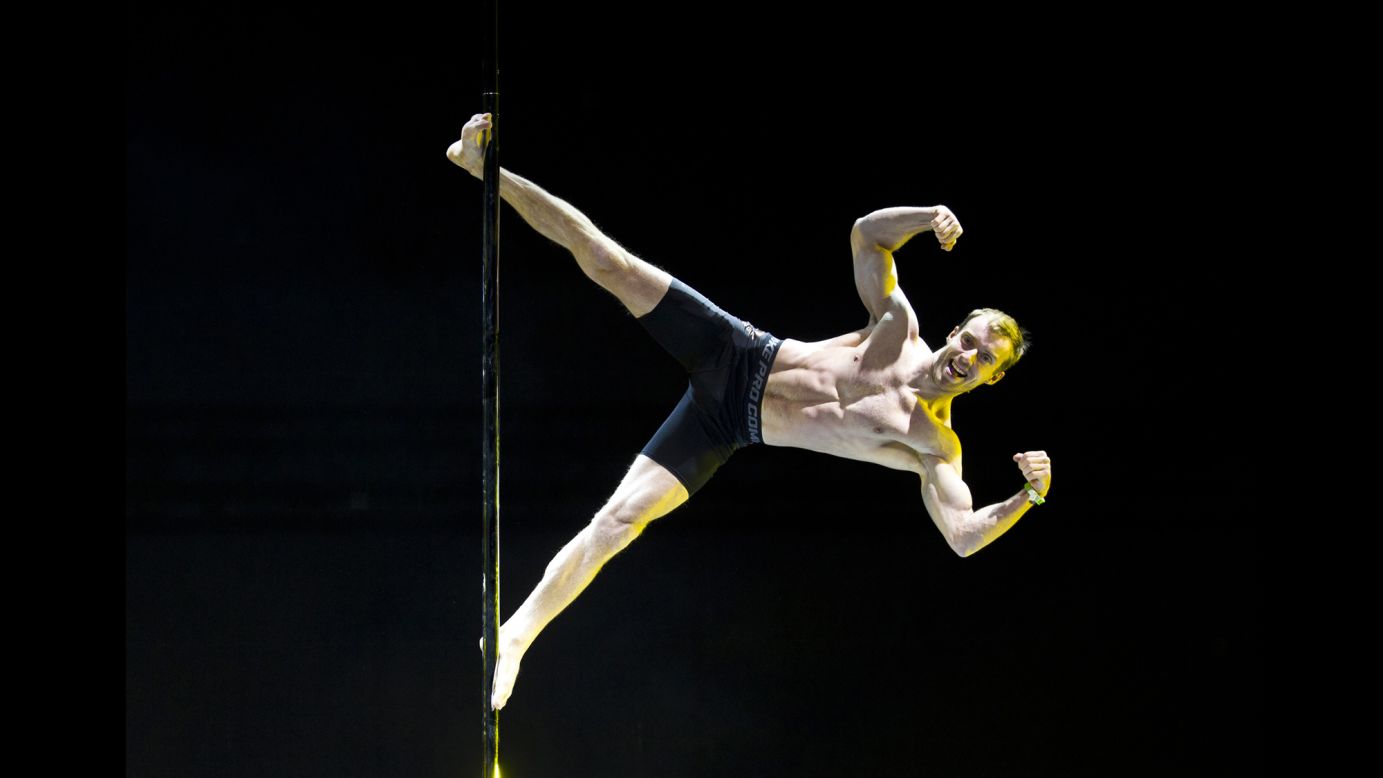 A competitor flexes Sunday, April 12, during the Pole Dancing World Championships in Beijing.