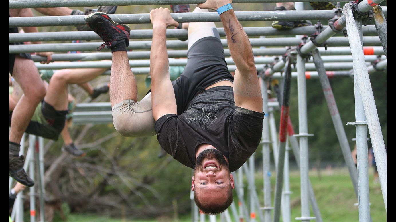 Kyle Chittinden hangs from the monkey bars on Saturday, April 11, during the Wairua Warrior obstacle race in Nelson, New Zealand.