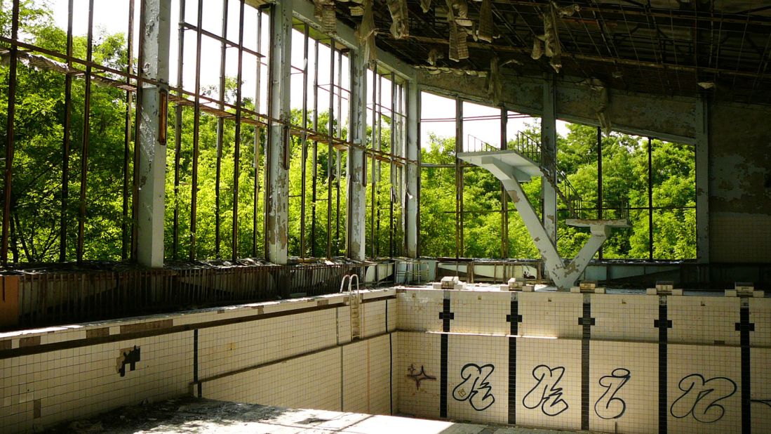 Three decades after the nuclear disaster there, guided tours take increasing numbers of tourists deep into Chernobyl's Exclusion Zone. Pripyat, the town built near the Chernobyl power plant, lies abandoned. This ruined swimming pool stands empty under rotting wooden beams. 