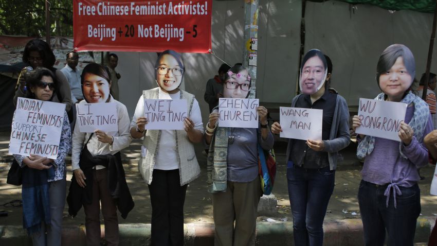 Indian women's rights activists wearing masks of five women's rights activists formally detained in China after Women's Day crackdown, hold placards with their names, to express their solidarity and demand their immediate release, in New Delhi, India, Wednesday, March 18, 2015. 