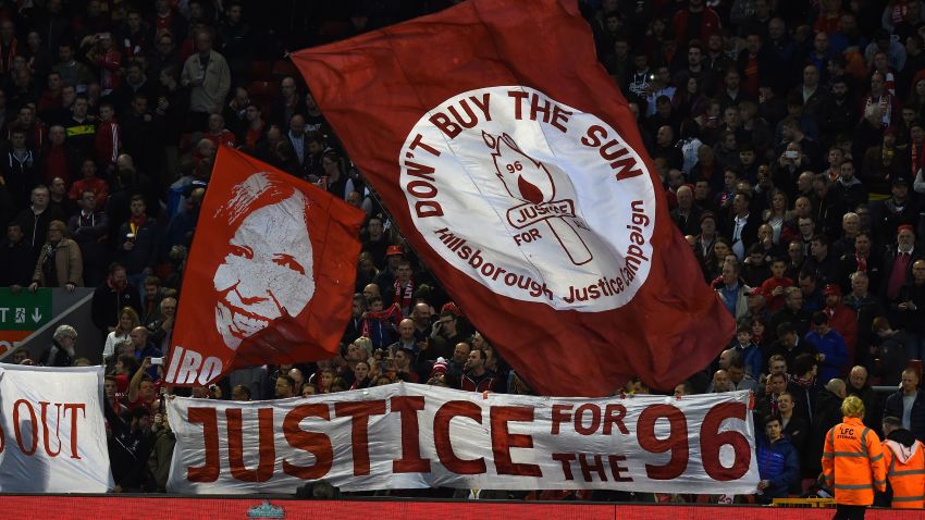 Banners in the crowd mark the 26th Anniversary of the Hillsborough disaster when 96 Liverpool fans died, ahead of the English Premier League football match between Liverpool and Newcastle United at Anfield in Liverpool, north west England on April 13, 2015. AFP PHOTO / PAUL ELLIS RESTRICTED TO EDITORIAL USE. NO USE WITH UNAUTHORIZED AUDIO, VIDEO, DATA, FIXTURE LISTS, CLUB/LEAGUE LOGOS OR LIVE SERVICES. ONLINE IN-MATCH USE LIMITED TO 45 IMAGES, NO VIDEO EMULATION. NO USE IN BETTING, GAMES OR SINGLE CLUB/LEAGUE/PLAYER PUBLICATIONS. (Photo credit should read PAUL ELLIS/AFP/Getty Images)