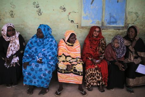 APRIL 14 - IZBA, SUDAN: Women wait for their turn to vote outside a polling station in an impoverished neighborhood on the outskirts of Khartoum, the capital city. This is the first day of the country's presidential and legislative elections, which could see current President Omar al-Bashir hold onto his leadership for another five years.