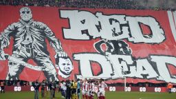 Standard de Liege fans display a banner featuring an illustration depicting the decapitation of Anderlecht midfielder Steven Defour before the Jupiler Pro League match between Standard de Liege and RSC Anderlecht, in Liege on January 25, 2015, on day 23 of the Belgian soccer championship. Fans of Belgian giants Standard Liege caused outrage when they unfurled a banner showing a mocked-up image of former captain Steven Defour being beheaded.