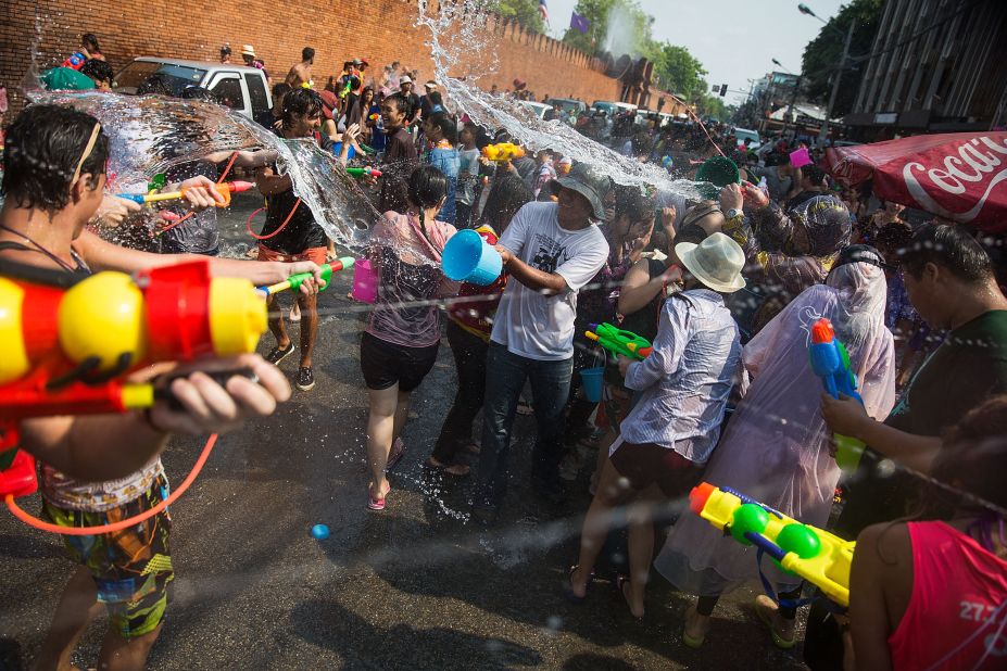 Thai locals and foreigners take part in a city-wide water fight on April 13, 2015 in Chiang Mai. Chiang Mai, in northern Thailand, has a reputation for holding the wildest Songkran festivities.