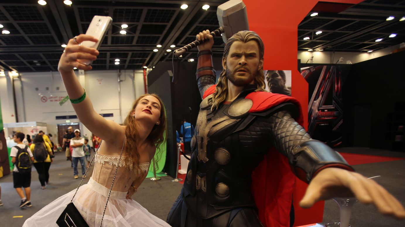 A woman takes a selfie next to a model of Thor during the Middle East Film & Comic Con in Dubai, United Arab Emirates, on Saturday, April 11.