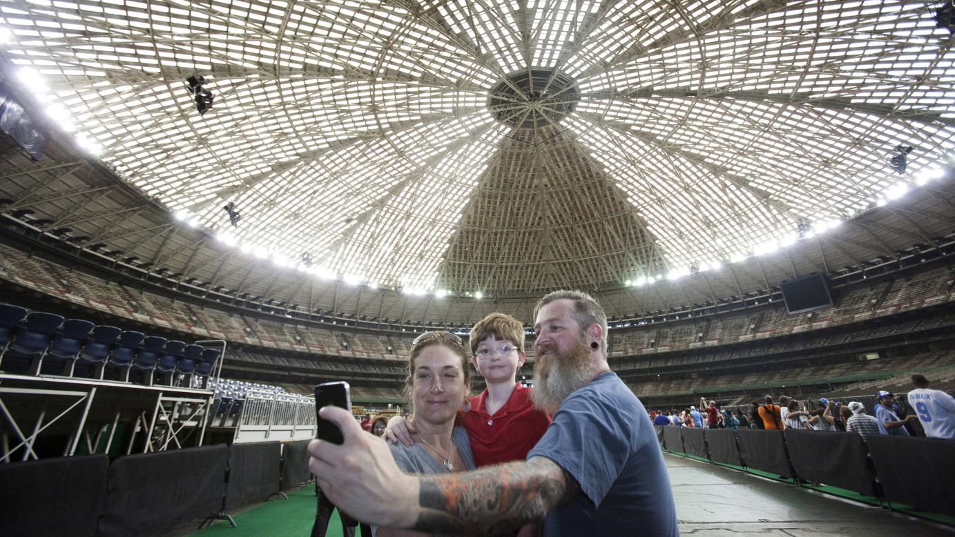 A family takes a selfie inside Houston's Astrodome on Thursday, April 9. The historic stadium was built 50 years ago.
