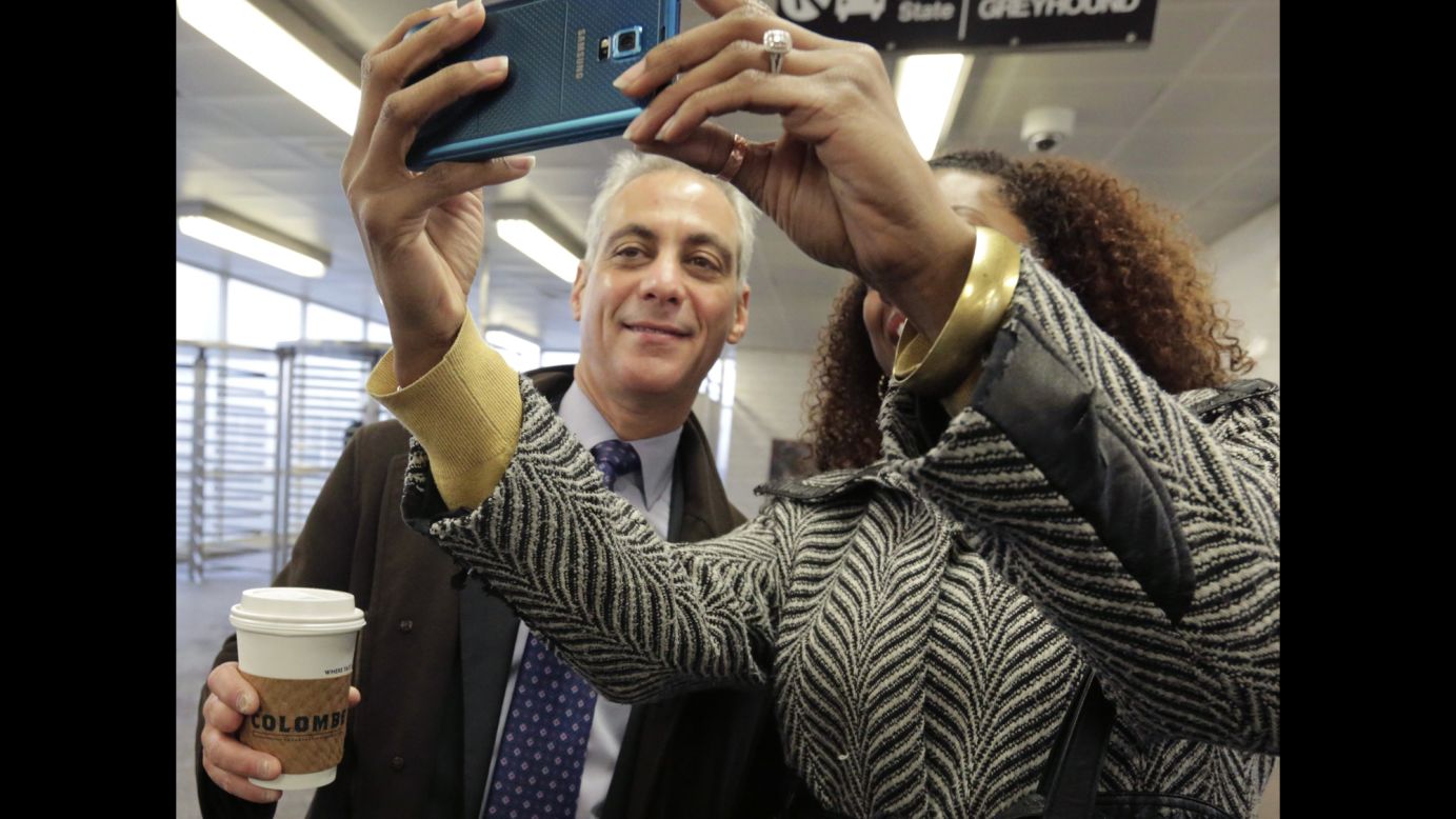 Chicago Mayor Rahm Emanuel pauses for a woman's selfie at a transit station in Chicago on Wednesday, April 8.