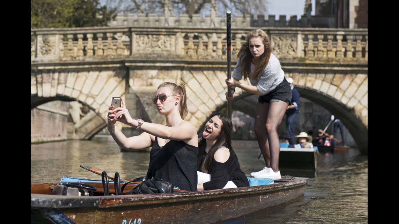 Young women pose for a selfie Friday, April 10, while on the River Cam in Cambridge, England.