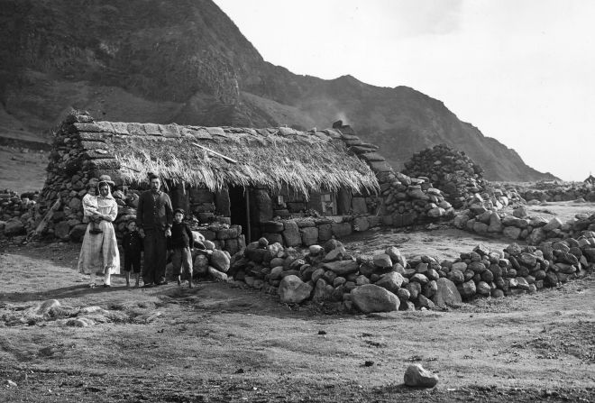 Next year the island will celebrate 200 years since it was annexed by the UK. Here, a family poses in front of their home in 1961.<br />