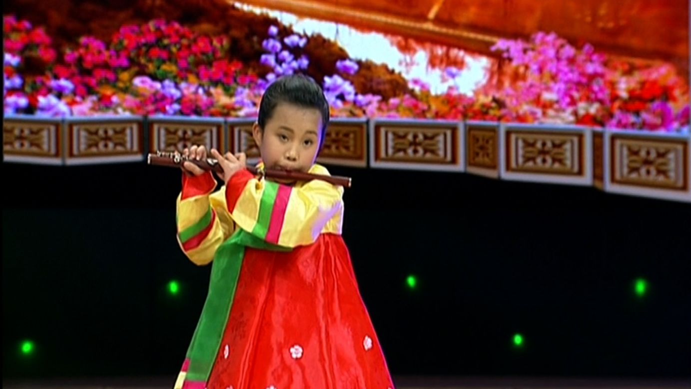 A young girl plays the flute in images on KCTV, North Korea's state television, to mark 103 years since the birth of the nation's founder Kim Il Sung.