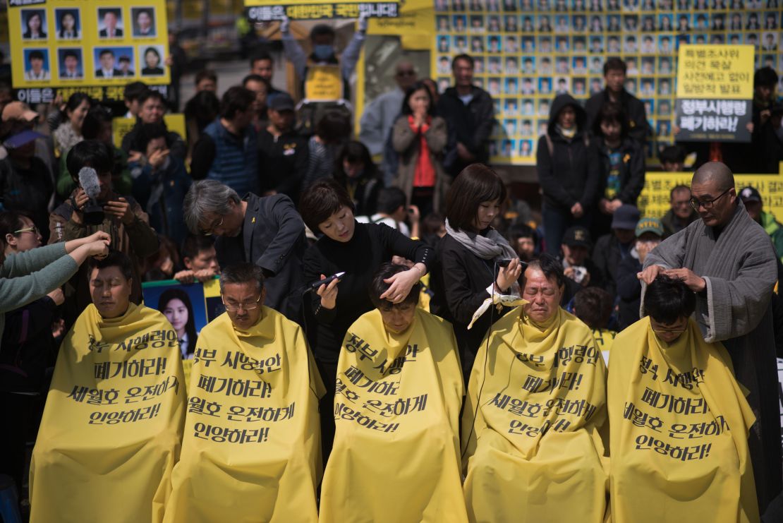 Relatives of victims of the Sewol ferry accident have their heads shaved during a protest in Seoul on April 2, 2015. 