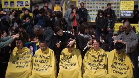 Relatives of victims of the Sewol ferry accident have their heads shaved during a protest in Seoul on April 2, 2015. 