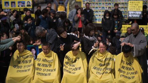 Relatives of victims of the Sewol ferry accident have their heads shaved during a protest in Seoul on April 2, 2015.