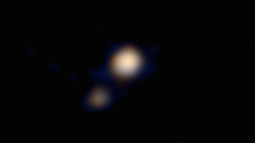 This image of Pluto and its largest moon, Charon, was taken by the Ralph color imager aboard NASA's New Horizons spacecraft on April 9 and downlinked to Earth the following day. It is the first color image ever made of the Pluto system by a spacecraft on approach. The image is a preliminary reconstruction, which will be refined later by the New Horizons science team. Clearly visible are both Pluto and the Texas-sized Charon. The image was made from a distance of about 71 million miles (115 million kilometers)-roughly the distance from the Sun to Venus. At this distance, neither Pluto nor Charon is well resolved by the color imager, but their distinctly different appearances can be seen. As New Horizons approaches its flyby of Pluto on July 14, it will deliver color images that eventually show surface features as small as a few miles across.