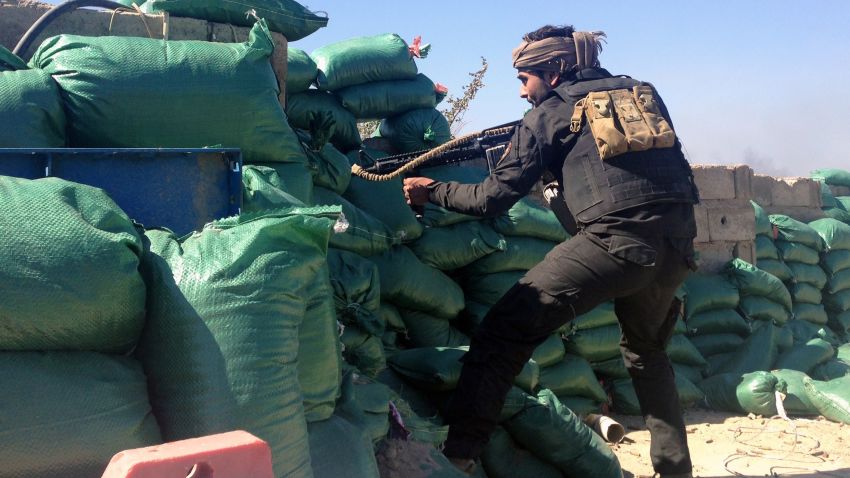 A member of the tribal groups fighting along with the Iraqi government security forces takes a position behind sandbags during clashes with jihadists in the Hosh district of Ramadi as the Islamic State jihadist group launched a coordinated attack on government-held areas of the western Iraqi city on March 11, 2015, involving seven almost simultaneous suicide car bombs, police said. At least 10 people were killed and 30 wounded in the attack, according to initial reports by police and hospital sources in the city, capital of Anbar province. AFP PHOTO / AZHAR SHALLAL (Photo credit should read AZHAR SHALLAL/AFP/Getty Images)