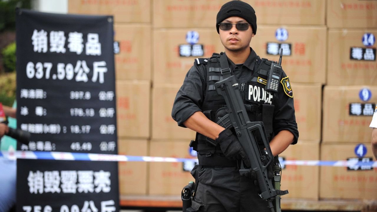 A policeman stands guard as a officials prepare to destroy illegal drugs at a factory in Guiyang, Guizhou Province in 2013.