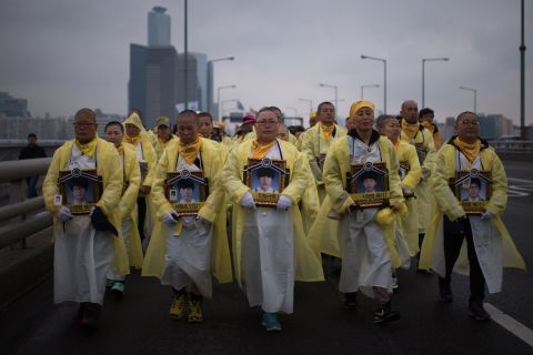 Relatives of victims of the Sewol ferry disaster march across a bridge over the Han river in Seoul on April 5, 2015. More than 200 people participated in the march from Ansan city. Many of them were the parents of the 250 students who died when the overloaded ferry sank off Jindo on April 16, 2014.