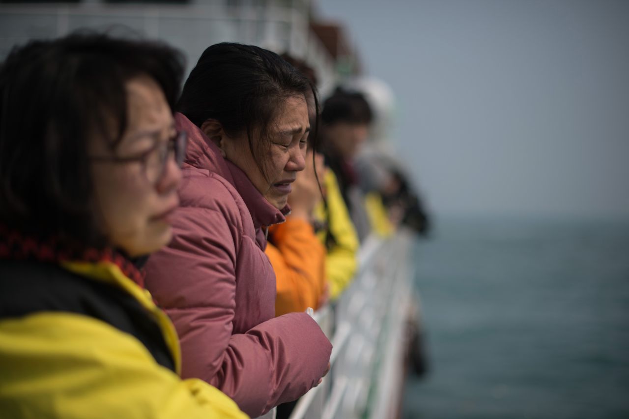 A relative of a victim weeps as she and others stand on the deck of a boat during a visit to the site of the sunken Sewol ferry on April 15, 2015 -- one day before the one year anniversary of the disaster.