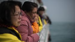 A relative of victims of the Sewol ferry disaster weeps as she and others stand on the deck of a boat during a visit to the site of the sunken ferry on April 15, 2015 in Jindo-gun, South Korea.