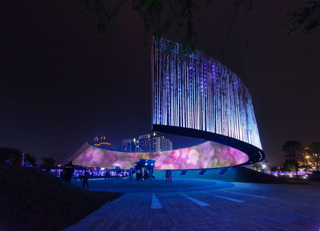 Built in honor of Taiwan's Lantern Festival by J.J. Pan and Partners, this giant lantern features a ring of moving images produced by projection technology and LED lighting. The choice of form and materials used for the lantern were inspired by the historical and cultural characteristics of Hsinchu, whose ancient name was "City of Bamboo Walls," says the firm.