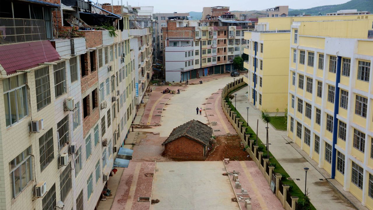 A house lies in the middle of a newly developed road in Nanning, Guangxi province on April 10, 2015. The owner was in a a dispute with the government over its demolition.