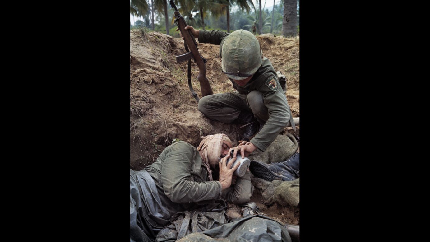 Staff Sgt. Harrison Pell, a wounded American soldier, drinks from a comrade's canteen during a January 1966 firefight between U.S. troops and a combined North Vietnamese and Viet Cong force.
