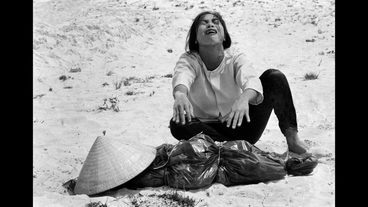 A South Vietnamese woman mourns over the body of her husband, which was found with 47 others in a mass grave near Hue in April 1969.