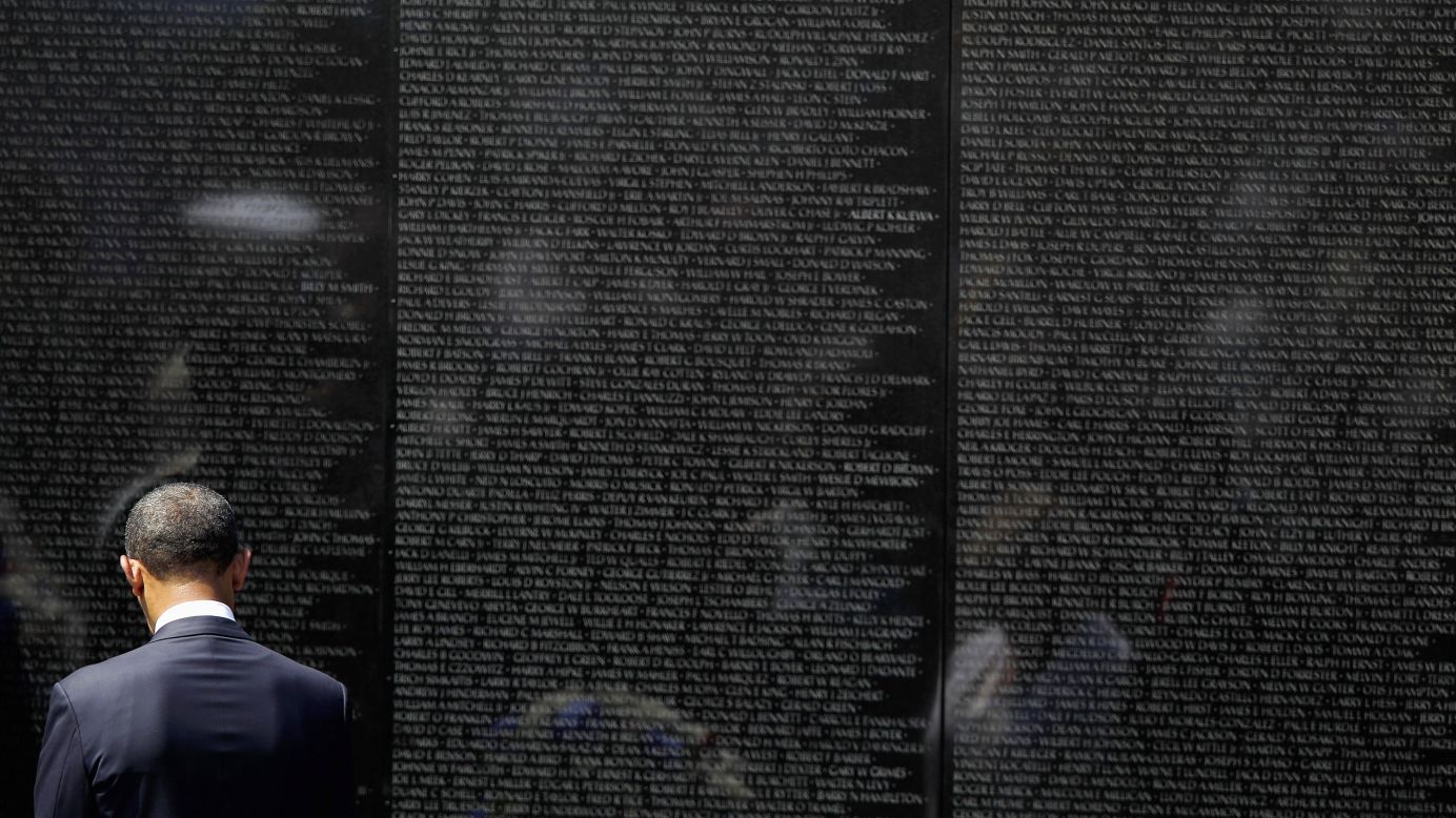 U.S. President Barack Obama stands at the Vietnam Veterans Memorial in Washington in May 2012. The black granite memorial bears the names of more than 58,000 Americans killed in the Vietnam War.