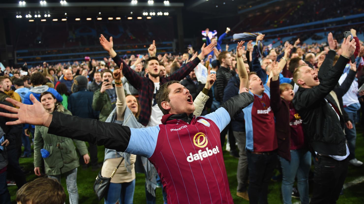Aston Villa fans celebrate victory on the pitch after the FA Cup Quarter Final match between Aston Villa and West Bromwich Albion at Villa Park on March 7, 2015 in Birmingham, England