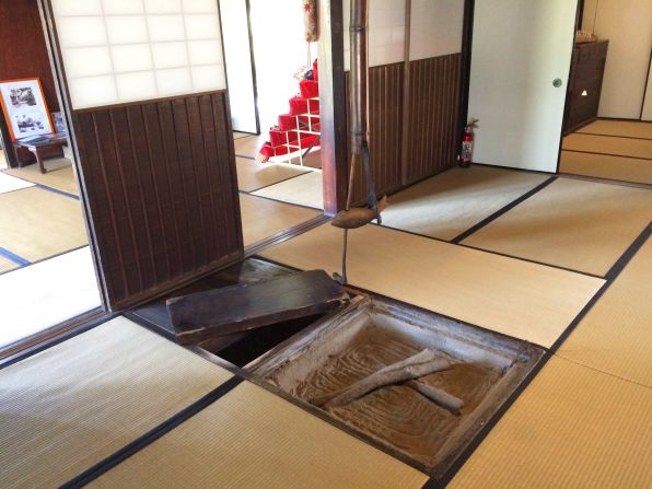 The dislodged floorboard leads to a hidden room where the Saisho clan held private meetings. A tour guide hops in during visits to show that the passage is as deep as a man's height.