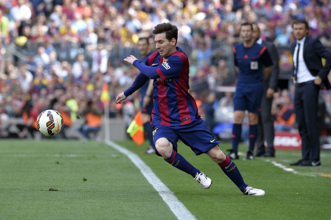 Lionel Messi dances around the Nou Camp touchline as Barcelona face Valencia.