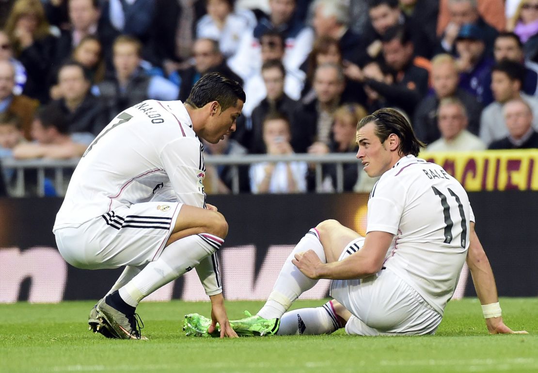 Gareth Bale (right) winces as he grabs his calf in Real Madrid's 3-1 victory over Malaga.