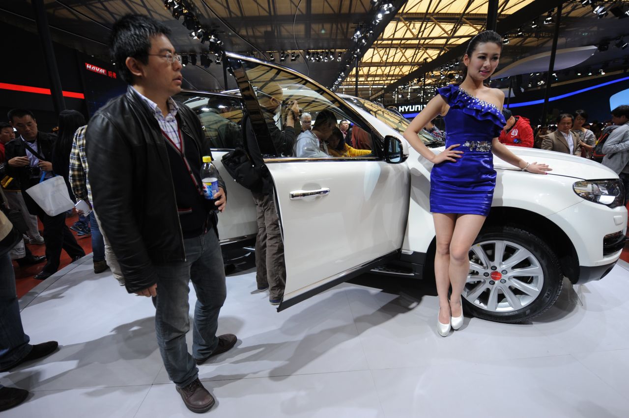 A visitor takes a look at a Haval SUV on the opening day of the Shanghai auto show on April 21, 2013. 