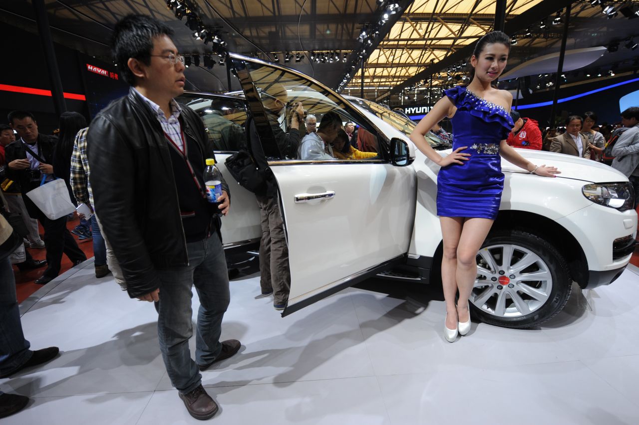 A visitor takes a look at a Haval SUV on the opening day of the Shanghai auto show on April 21, 2013.