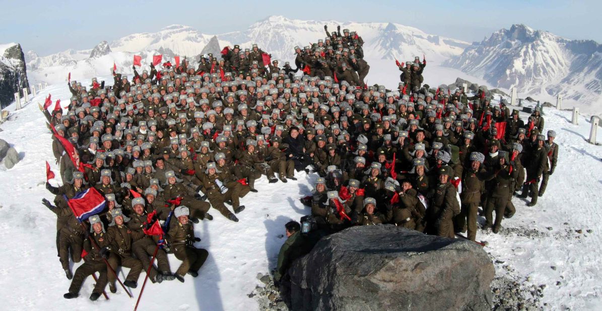 Kim Jong Un, center, poses with soldiers on the snow-covered top of Mount Paektu in an April 18 photo released by South Korean news agency Yonhap.