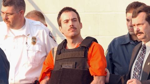 Bombing suspect Eric Robert Rudolph is escorted from the Cherokee County Jail 