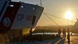 Shipwrecked migrants sit on the quayside after disembarking from a rescue vessel in the Italian port of Augusta in Sicily on April 16, 2015. As many as 41 migrants drowned after a small boat carrying refugees sank in the Mediterranean, Italian media said, days after 400 were lost in another shipwreck. Four survivors told Italian police and humanitarian organisations that their inflatable vessel sank not long after leaving the coast of Libya for Europe with 45 people on board. AFP PHOTO / GIOVANNI ISOLINO (Photo credit should read GIOVANNI ISOLINO/AFP/Getty Images)