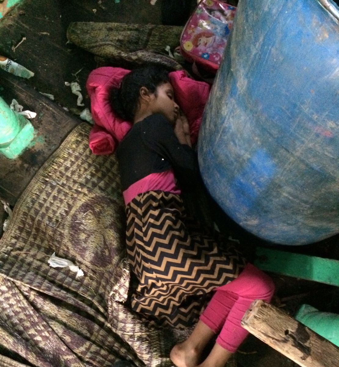 Maysa lies curled around an oil drum during a boat ride from Aden to Djibouti in April.